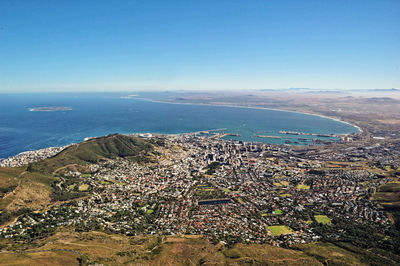 High angle view of townscape by sea against sky