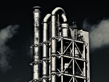 Low angle view of smoke stack against sky