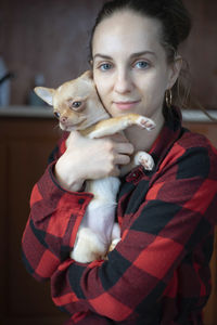 Woman holding a small dog