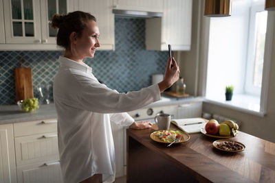 Happy businesswoman making video call during breakfast