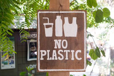 Close-up of sign board on tree