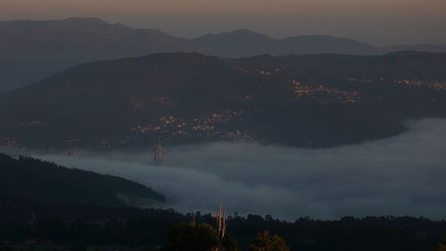 Scenic view of silhouette mountains against sky at sunset