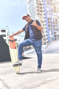 The perfect way to get through these streets, teenager in street clothes stands with a longboard