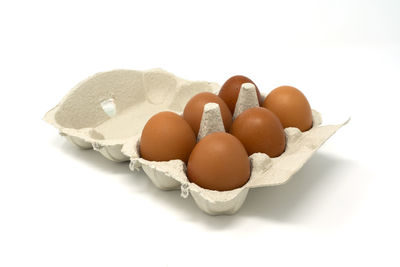 Close-up of eggs against white background