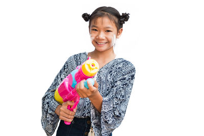 Portrait of a smiling young woman against white background