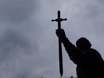 Low angle view of statue against cloudy sky