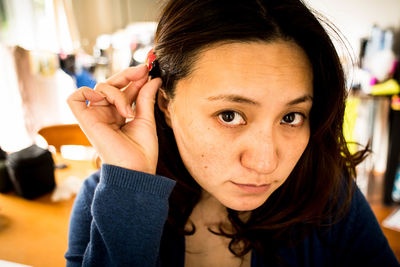 Close-up portrait of smiling woman at home