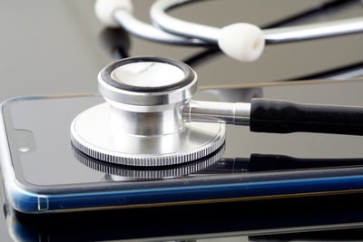 Stethoscope and mobile phone on table