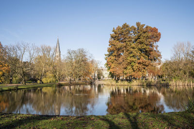 Scenic view of lake by trees against clear sky