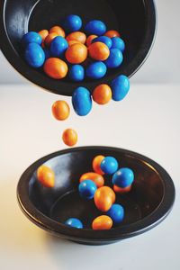 Closeup shot of blue and orange candys on black plates
