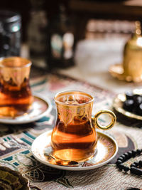 A glass of turkish tea on the table. conceptual stilllife photograhy with ramadan vibes concept