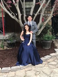 Full length portrait of elegant couple at outdoor party