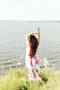 Full length of woman at beach against sky