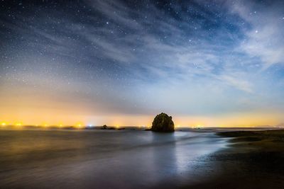 Scenic view of sea against sky at night