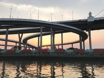 Bridge over river against sky during sunset