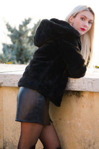 Portrait of a beautiful young woman standing outdoors