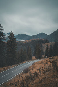 Scenic view of road by mountains against sky  brasov, romania