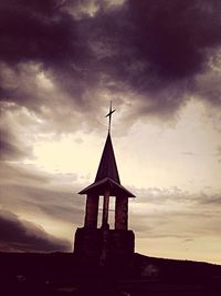 Low angle view of church against cloudy sky