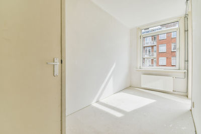 Rear view of woman sitting on wall