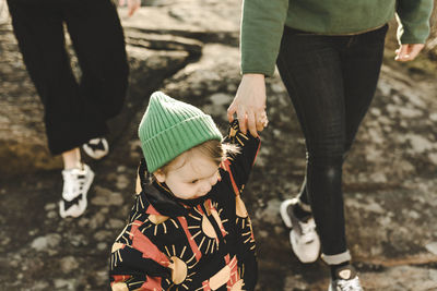 Daughter holding mothers hand