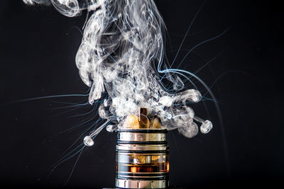 Close-up of electronic cigarette against black background