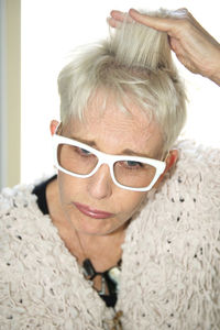 Close-up of worried senior woman touching hair