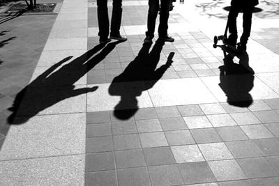 Low section of woman standing on tiled floor