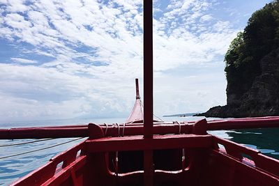 Boat moored on sea against sky