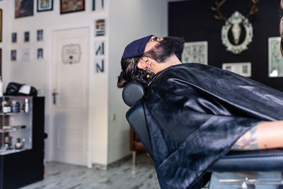 Side view of young man at home