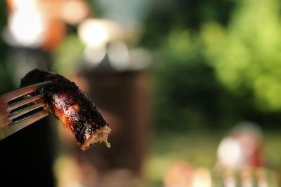 Close-up of bratwurst on fork