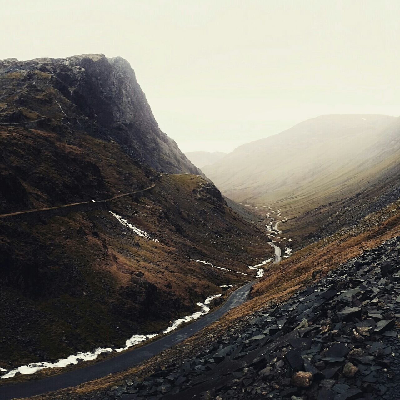 AERIAL VIEW OF VALLEY AND MOUNTAINS AGAINST SKY