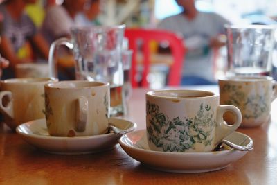 Close-up of coffee cups on table at restaurant