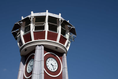 Low angle view of clock tower against blue sky