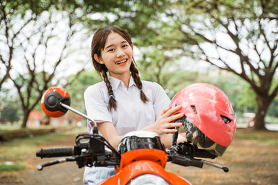 Side view of young woman riding motorcycle