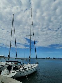 Sailboats sailing in sea against sky