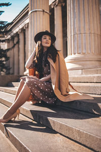 Portrait of young woman sitting outdoors