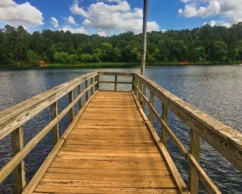 Pier over lake against sky