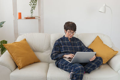 Young woman using laptop at home