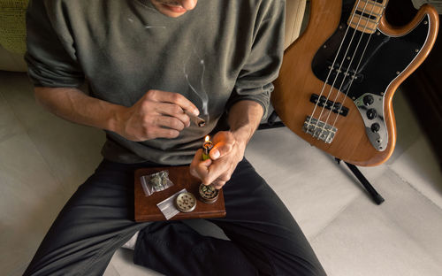 High angle view of man playing guitar