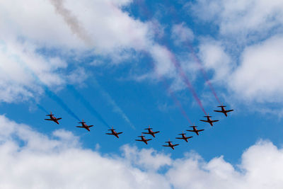 Low angle view of airshow against sky