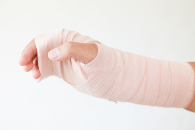 Close-up of woman hand over white background