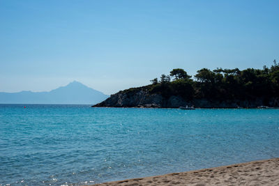 Scenic view of sea against clear blue sky