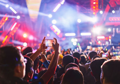 People enjoying music concert at night