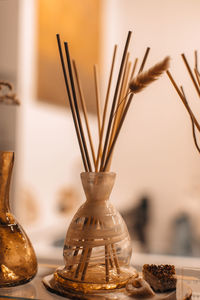 Beige brown glass bottle with wood stick aroma diffusers on stone shelf. home decoration. 