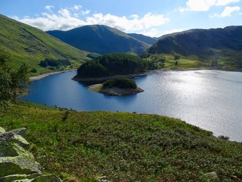 Scenic view of lake and mountains against sky