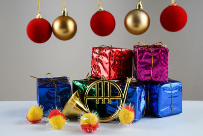 Multi colored decoration hanging on table against wall