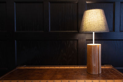 Close-up of illuminated lamp on table at home