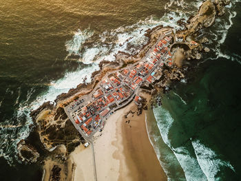 Aerial view of building at beach during sunset