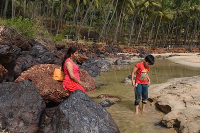 Rear view of people on rock