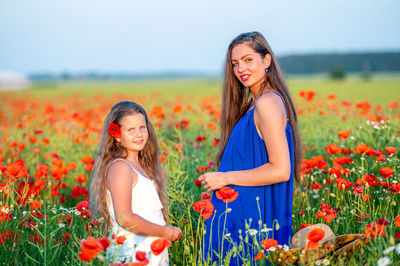 Portrait of smiling young woman holding flowers